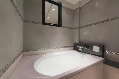 a white bathroom with a sink and a window at HOTEL REFRAIN in Tokyo