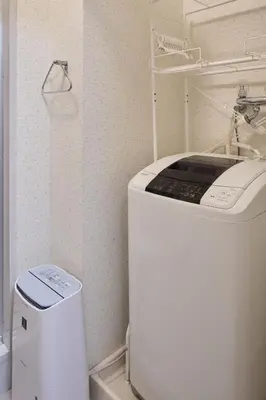 a washer and dryer in a small room with at Holiday Places /SHIBUYA 5min by train (Sangenjaya) in Tokyo