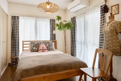 a bedroom with a bed and a potted plant at Holiday Places /SHIBUYA 5min by train (Sangenjaya) in Tokyo