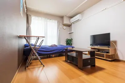 a room with a bed and a desk and a table at Minimalism HOTEL TOKYO Katsushika in Tokyo