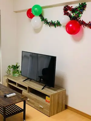 a living room with a television and balloons on the wall at K&M Heights - Vacation STAY 20628v in Tokyo