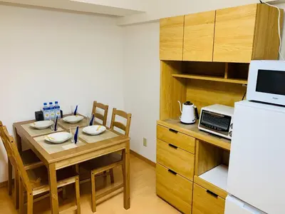 a small kitchen with a table and a refrigerator at K&M Heights - Vacation STAY 20628v in Tokyo