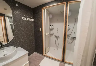 a bathroom with a shower and a sink at Business Hotel Kankokukan in Tokyo