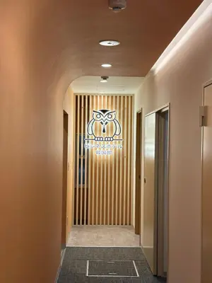 a hallway with a sign on the wall at Business Hotel Kankokukan in Tokyo