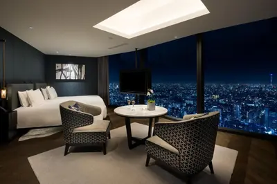 a hotel room with a bed and a table and chairs at BELLUSTAR TOKYO, A Pan Pacific Hotel in Tokyo