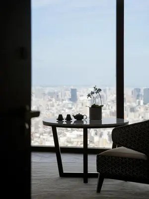 a table and a chair in a room with a window at BELLUSTAR TOKYO, A Pan Pacific Hotel in Tokyo