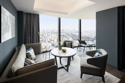a living room with a couch and chairs and a table at BELLUSTAR TOKYO, A Pan Pacific Hotel in Tokyo
