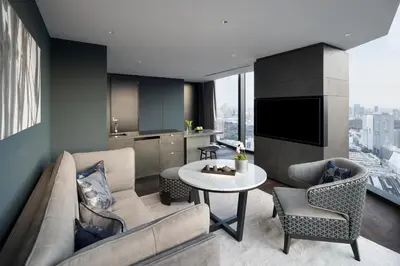 a living room with a couch and a table at BELLUSTAR TOKYO, A Pan Pacific Hotel in Tokyo