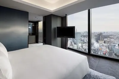 a bedroom with a large white bed and a large window at BELLUSTAR TOKYO, A Pan Pacific Hotel in Tokyo