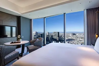 a bedroom with a large white bed and a large window at BELLUSTAR TOKYO, A Pan Pacific Hotel in Tokyo