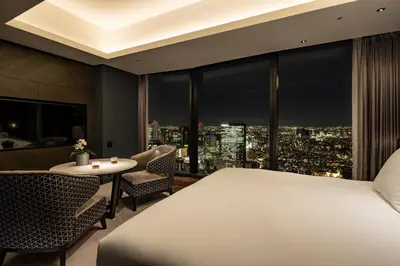 a hotel room with a bed and a view of a city at BELLUSTAR TOKYO, A Pan Pacific Hotel in Tokyo
