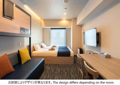 a hotel room with a bed and a couch at stayme THE HOTEL\u6d45\u8349\u30ea\u30d0\u30fc\u30b5\u30a4\u30c9 in Tokyo