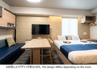 a hotel room with two beds and a table and a tv at stayme THE HOTEL\u6d45\u8349\u30ea\u30d0\u30fc\u30b5\u30a4\u30c9 in Tokyo