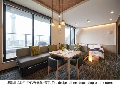 a living room with a couch and a table at stayme THE HOTEL\u6d45\u8349\u30ea\u30d0\u30fc\u30b5\u30a4\u30c9 in Tokyo