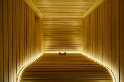 a sauna with a bench in the middle of it at Boutique Sauna ARCH in Tokyo