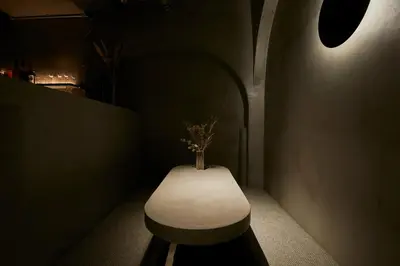 a room with a bench with a vase on it at Boutique Sauna ARCH in Tokyo