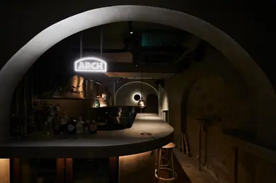 a kitchen with a bar in a dark room at Boutique Sauna ARCH in Tokyo