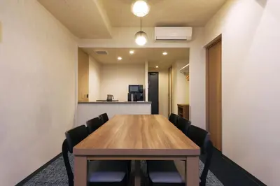 a conference room with a wooden table and chairs at stayme THE HOTEL\u4e0a\u91ce\u99c5\u524d in Tokyo