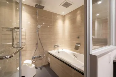 a bathroom with a tub and a sink and a shower at stayme THE HOTEL\u4e0a\u91ce\u99c5\u524d in Tokyo