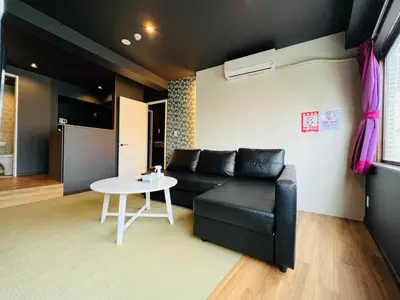 a living room with a black couch and a table at Asakusa-Smile-SM0141 in Tokyo