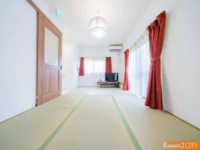a hallway with a door and a chair in a room at 5min walk to Tokyo Skytree Sta -HANA ASAKUSA- in Tokyo