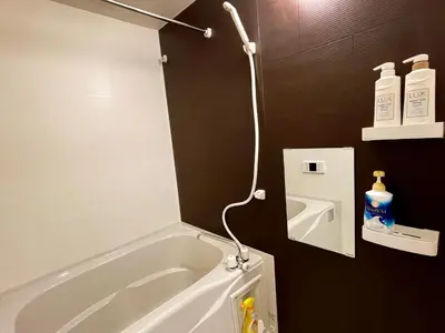 a bathroom with a bath tub with a shower at PRISM Inn Komagata Asakusa in Tokyo