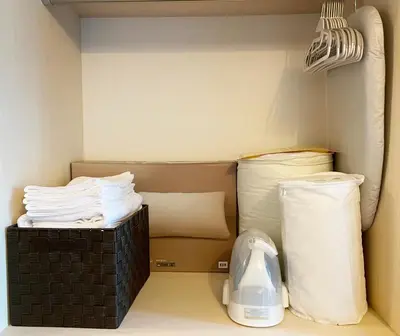 a room with a bed with white pillows at PRISM Inn Komagata Asakusa in Tokyo