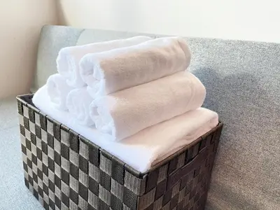 a pile of towels in a basket on the floor at PRISM Inn Komagata Asakusa in Tokyo