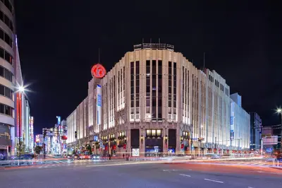 a large building on a city street at night at HOTEL MYSTAYS Nishi Shinjuku in Tokyo