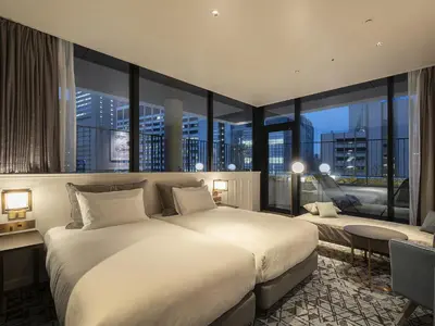 a bedroom with a large bed and a large window at GINZA HOTEL by GRANBELL in Tokyo