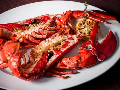 a plate of lobsters and other seafood on a table at GINZA HOTEL by GRANBELL in Tokyo