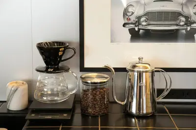 a table with a coffee pot and a blender and nuts at PDO INN Coffee & Open-air bath on the roof in Tokyo