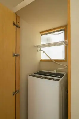 a small kitchen with a refrigerator and a window at PDO INN Coffee & Open-air bath on the roof in Tokyo