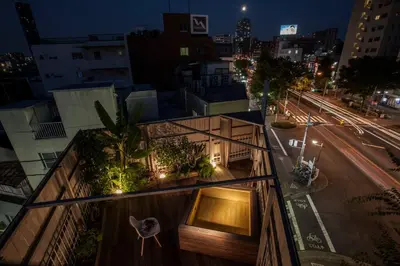 a view of a building at night with a street at PDO INN Coffee & Open-air bath on the roof in Tokyo