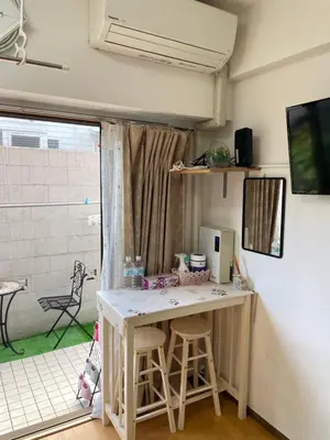 a room with a desk with a computer on it at \u685c\u306e\u5bbf28 square meter king size bed with sofa bed, garden room102 in Tokyo