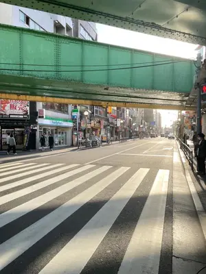 an empty city street with a bridge over it at \u685c\u306e\u5bbf28 square meter king size bed with sofa bed, garden room102 in Tokyo