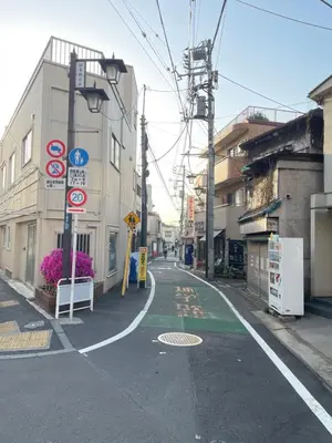 an empty street with signs on the side of a building at \u685c\u306e\u5bbf28 square meter king size bed with sofa bed, garden room102 in Tokyo