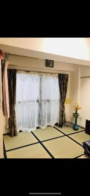 a living room with a window with white curtains at \u6771\u6d0b\u306e\u5bb6-26 square meter Treadmi Garden House101 in Tokyo