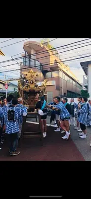 a group of girls in blue and white uniforms standing around a machine at \u6771\u6d0b\u306e\u5bb6-26 square meter Treadmi Garden House101 in Tokyo