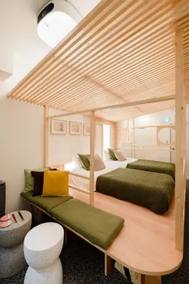 two twin beds in a room with at Hotel Lux in Tokyo
