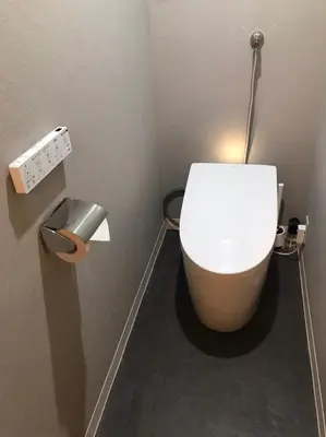 a bathroom with a white toilet in a stall at Hotel Lux in Tokyo