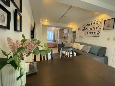 a living room with a table and a couch at Hotel Lux in Tokyo