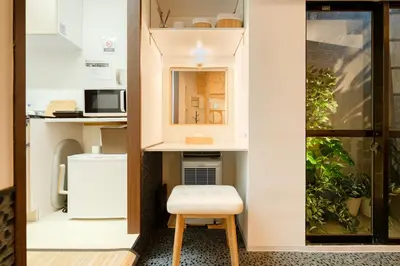a small room with a table and a stool at Hotel Lux in Tokyo