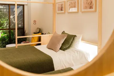 a bedroom with a bed and a large window at Hotel Lux in Tokyo