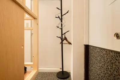 a room with a black pole in the corner at Hotel Lux in Tokyo