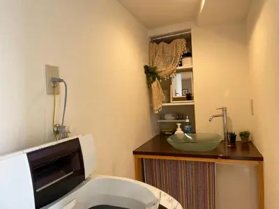 a bathroom with a toilet and a sink at Hotel Lux in Tokyo