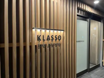 a building with a sign on the side of it at KLASSO Tokyo Sumiyoshi Apartments in Tokyo