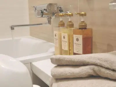 a bathroom with two bottles of soap on a counter at KLASSO Tokyo Sumiyoshi Apartments in Tokyo