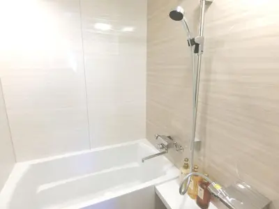 a bathroom with a bath tub and a shower at KLASSO Tokyo Sumiyoshi Apartments in Tokyo