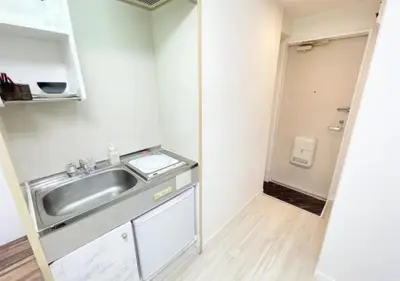a small kitchen with a sink in a room at Beverly Homes Osaki by Tranova in Tokyo